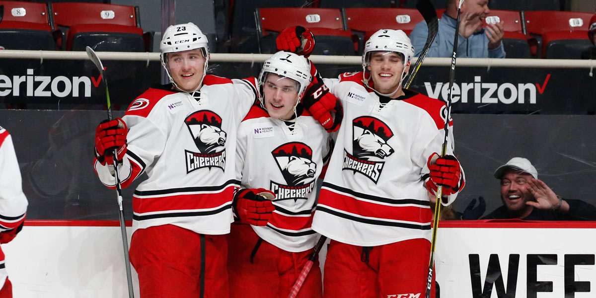 The Charlotte Checkers celebrate Aleksi Saarela's goal in the team's 8-2 victory over the Providence Bruins
